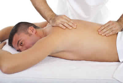 young man with fibromyalgia pain having massage treatment at our Cardiff clinic