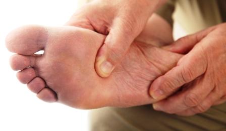 man showing foot with Plantar Fasciitis heel pain