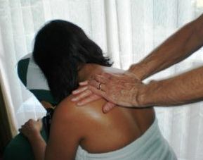 lady with dark skin having shoulder massage for her shoulder pain at our Cardiff clinic