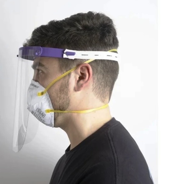 a therapist wearing a COVID-19 face shield visor to protect from coronavirus