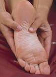man getting a foot reflexology treatment in Cardiff for his asthma an hay fever