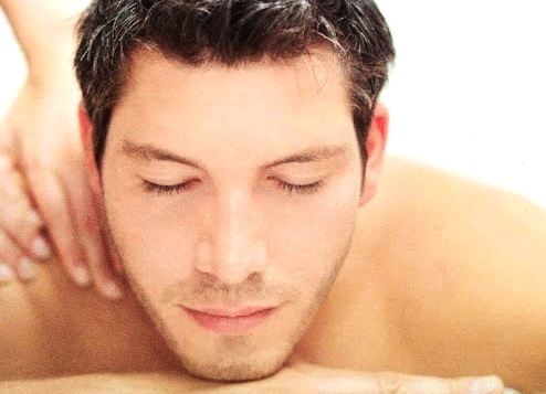 man in Cardiff having oil sports massage for neck pain