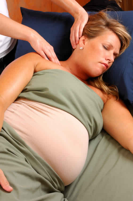 pregnant woman getting pregnancy massage and reflexology at our Cardiff clinic